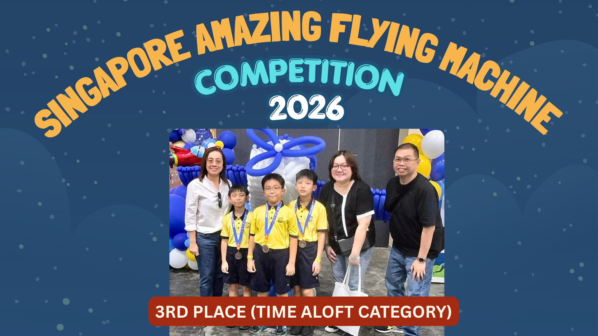 Students in yellow uniforms hold paper planes in front of a Singapore Amazing Flying Machine Competition 2024 banner.